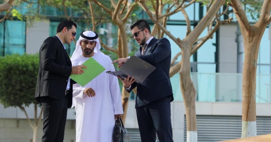 Businessmen standing talking to each other |-