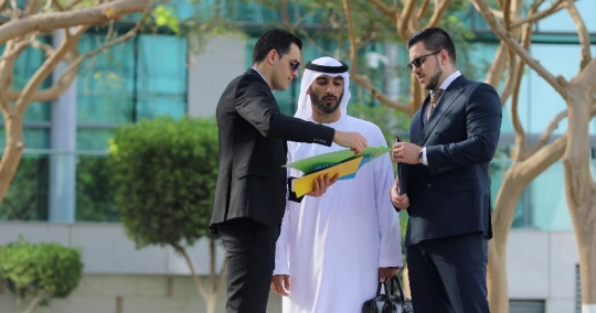 Businessmen standing talking to each other outside |-