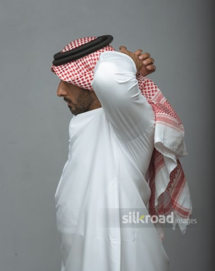 Middle Eastern Businessman fixing his ghutra|
