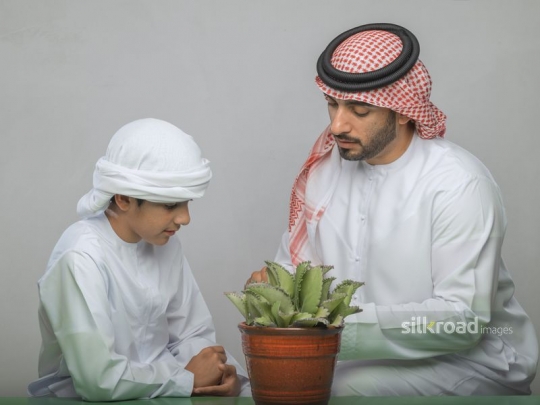 Middle Eastern father spending time with son|