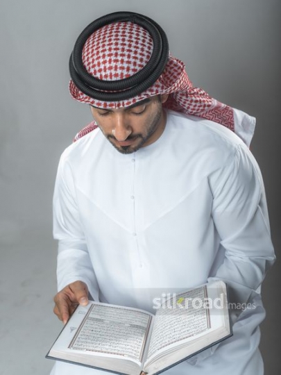 Top view of an arabian man reading the  Qur'an|