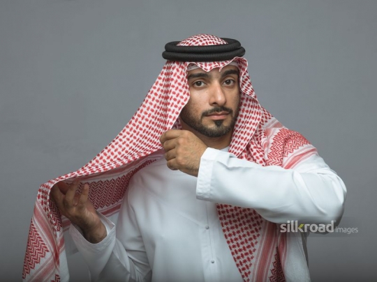 Middle Eastern business man fixing his ghutra|