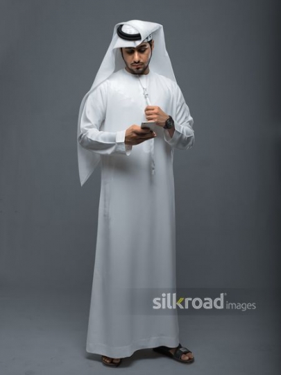 Arab man using his mobile|
