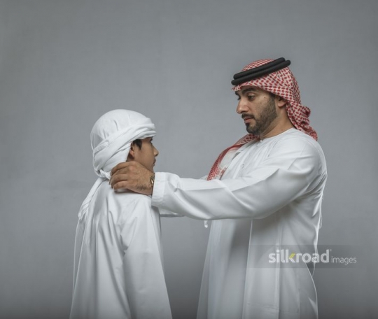 Middle Eastern man talking to the young boy