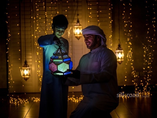Boy celebrating ramadan with father|-