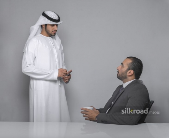 Arab colleagues discussing work |