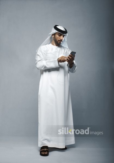 Businessman talking on the phone using his earphones|