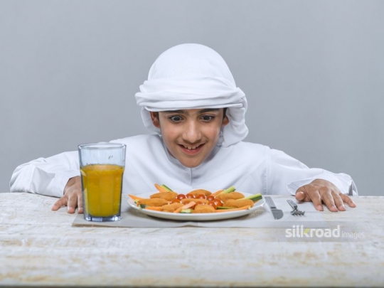 Young arab boy excited to eat
