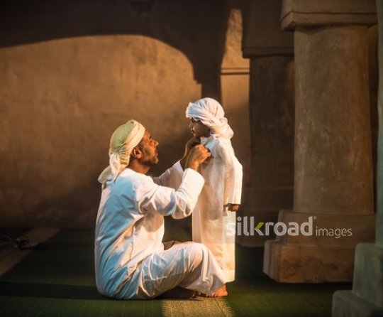 Old man fixing outfit of grandson|-