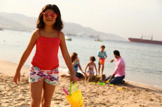 Family Having Fun By The Beach