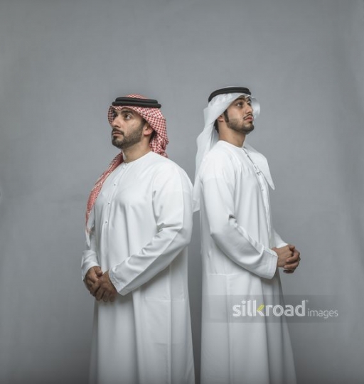 Middle Eastern men dressed in the traditional UAE attire|