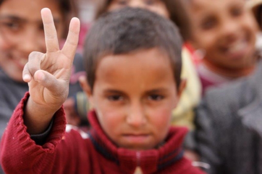 Syrian Kid show victory sign from Zaatari refugee camp for Syrian refugees