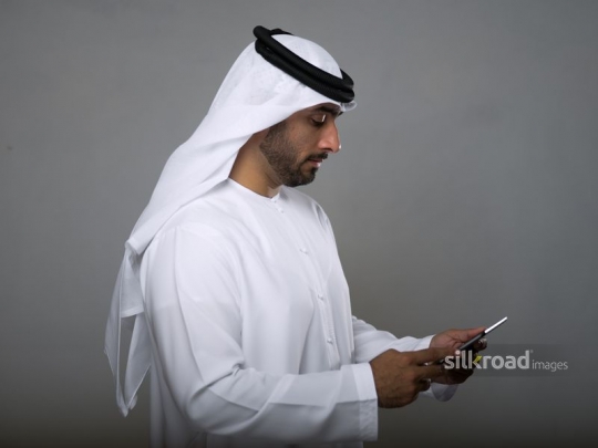 Middle eastern man working on the device|
