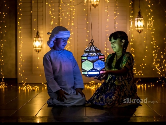 Brother and sister holding lantern|-