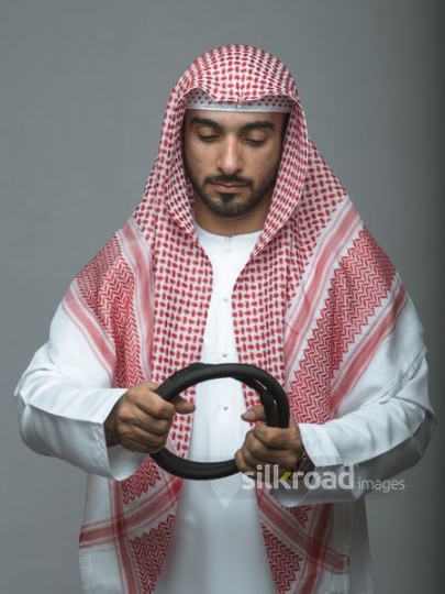 Arabian man getting dressed