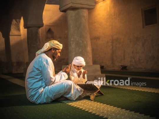 Old man and boy praying at the mosque|-