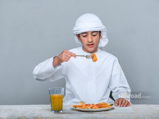 Little boy eating with joy