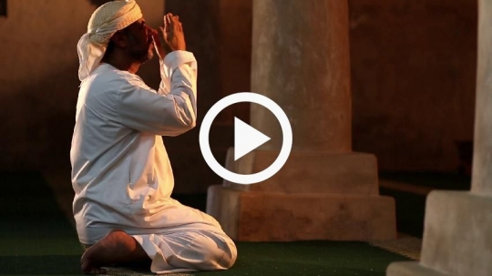 Old man raising his hands during prayer
