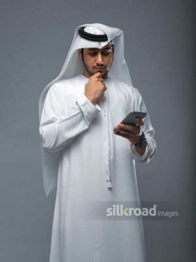 Middle Eastern man using his mobile|