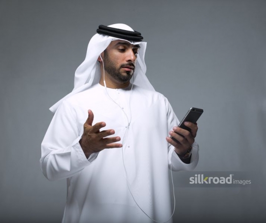 Businessman confused using his mobile|