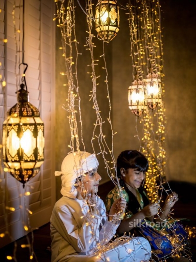 Boy and girl playing with ornaments|-