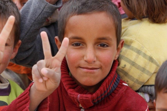 Syrian Kid show victory sign from Zaatari refugee camp for Syrian refugees