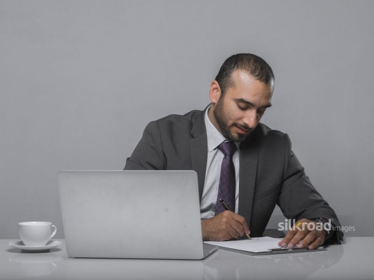 Businessman writing notes