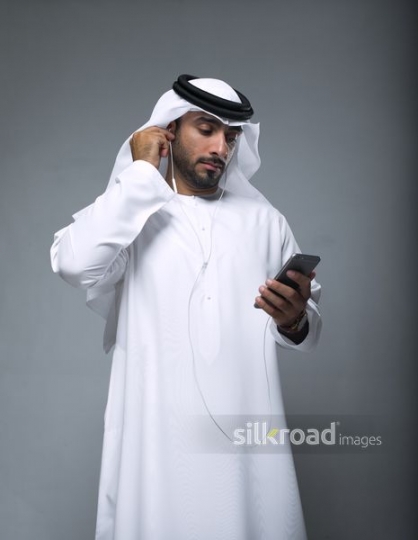 Businessman fixing his earphones|
