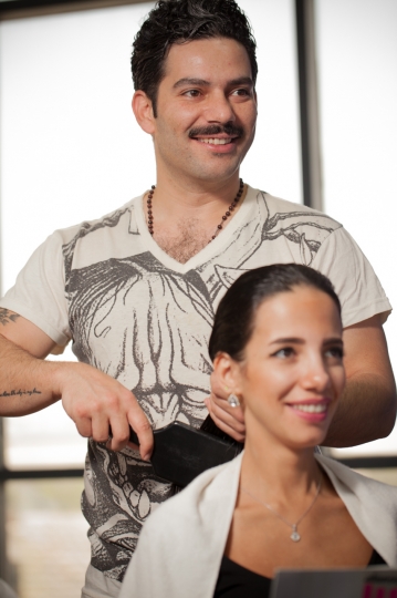 Middle Eastern hair dresser brushing the woman's hair|