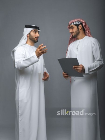 Middle Eastern Business manager talking to employee|