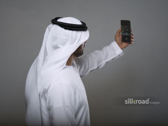 Middle Eastern man taking a selfie |