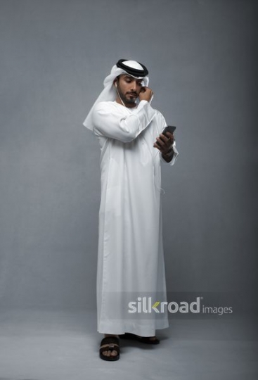 Middle Eastern man fixing his earphones