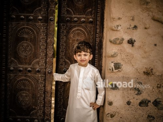 Boy standing at the door|-