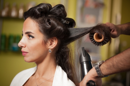 Middle Eastern woman getting a blow dry at the hair salon|