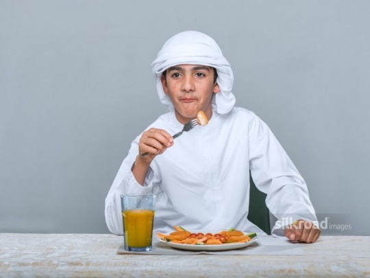 Middle Eastern boy eating