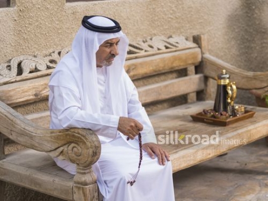 Arab man sitting with his misbahah in his hand|-