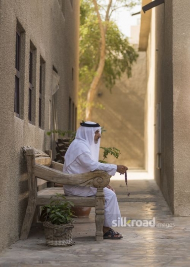 Arabian man praying using his Misbaha|-