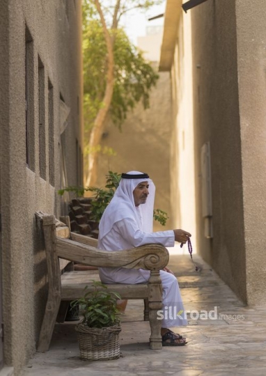 Middle Eastern man praying using his Misbahah|-