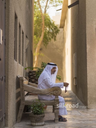 Arab grandfather sitting with his Misbahah|-