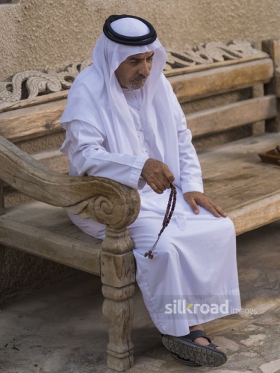 Arab grandfather sitting with is misbahah in his hand|-