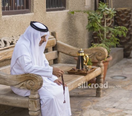 Arab man sitting on the bench with his misbaha|-