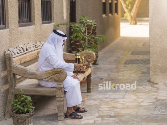 Arab grandfather sitting with his misbahah in his hand|-