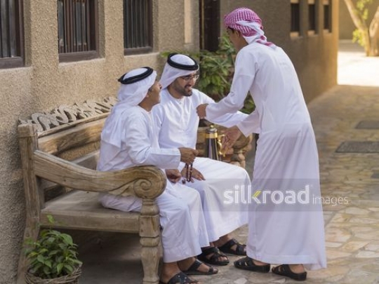 Arab son saying hello to his father and grandfather|-