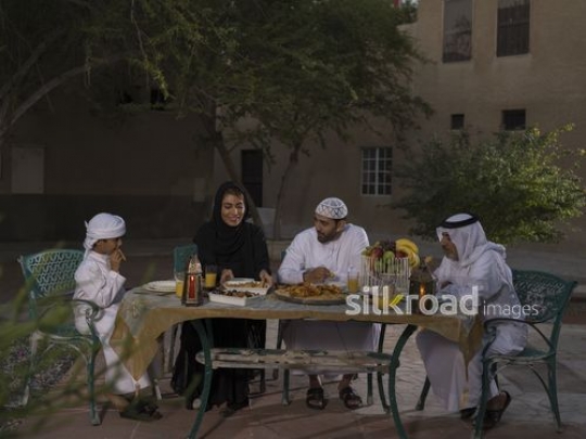 REPLACE - Middle Eastern family sitting together having Iftar |-
