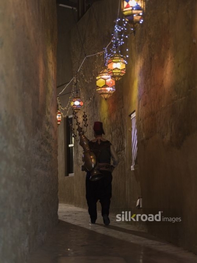 Middle Eastern Ramadan drink seller walking|-