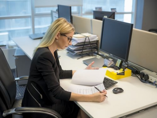 Western woman at her desk working|