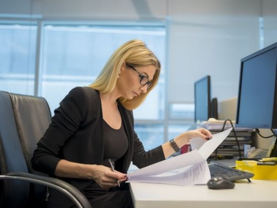 Business woman sitting at her desk working|