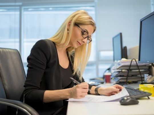 Side view of a western business woman working at the office|