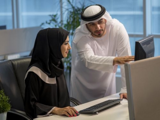 Arab business man and business woman at the office working together|