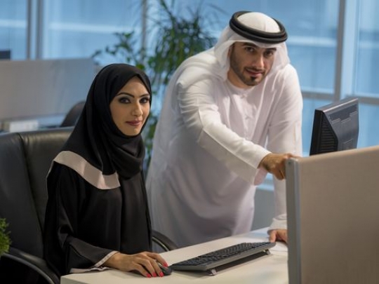 Business woman and businessman smiling|